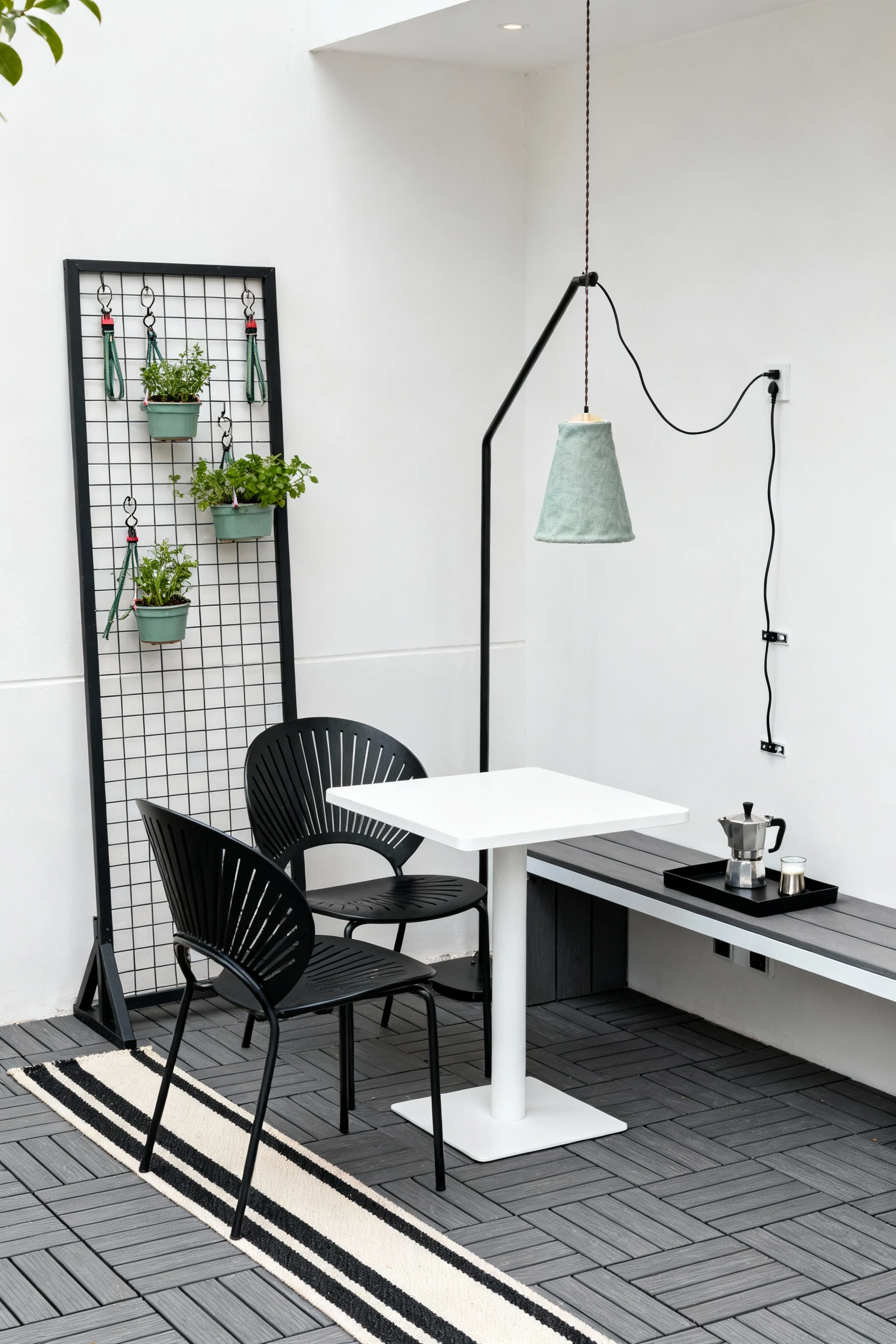 Photorealistic straight-on medium shot of a minimalist café corner: graphite composite deck tiles with a thin-striped bl