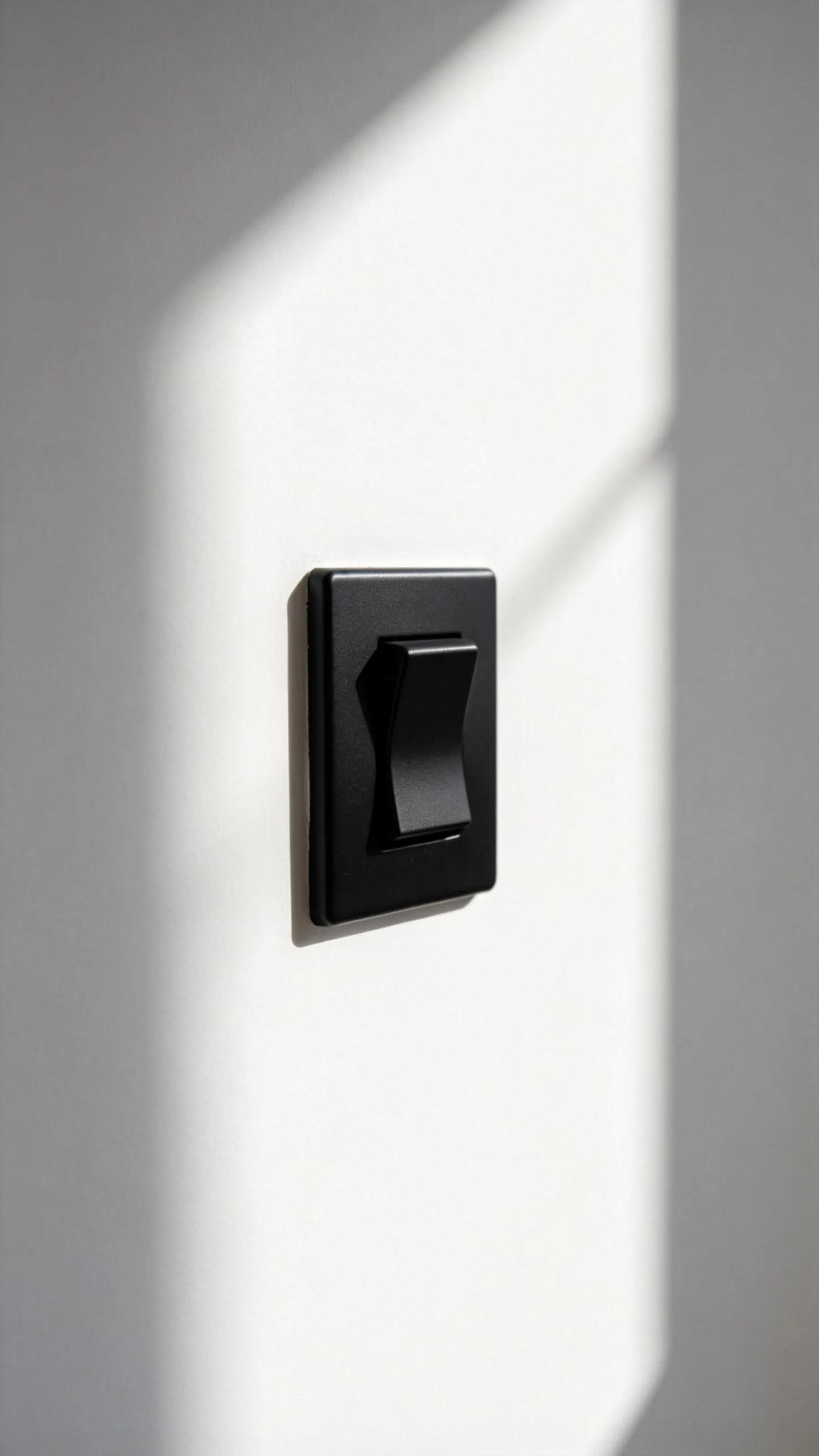 Black Switch on a White Wall